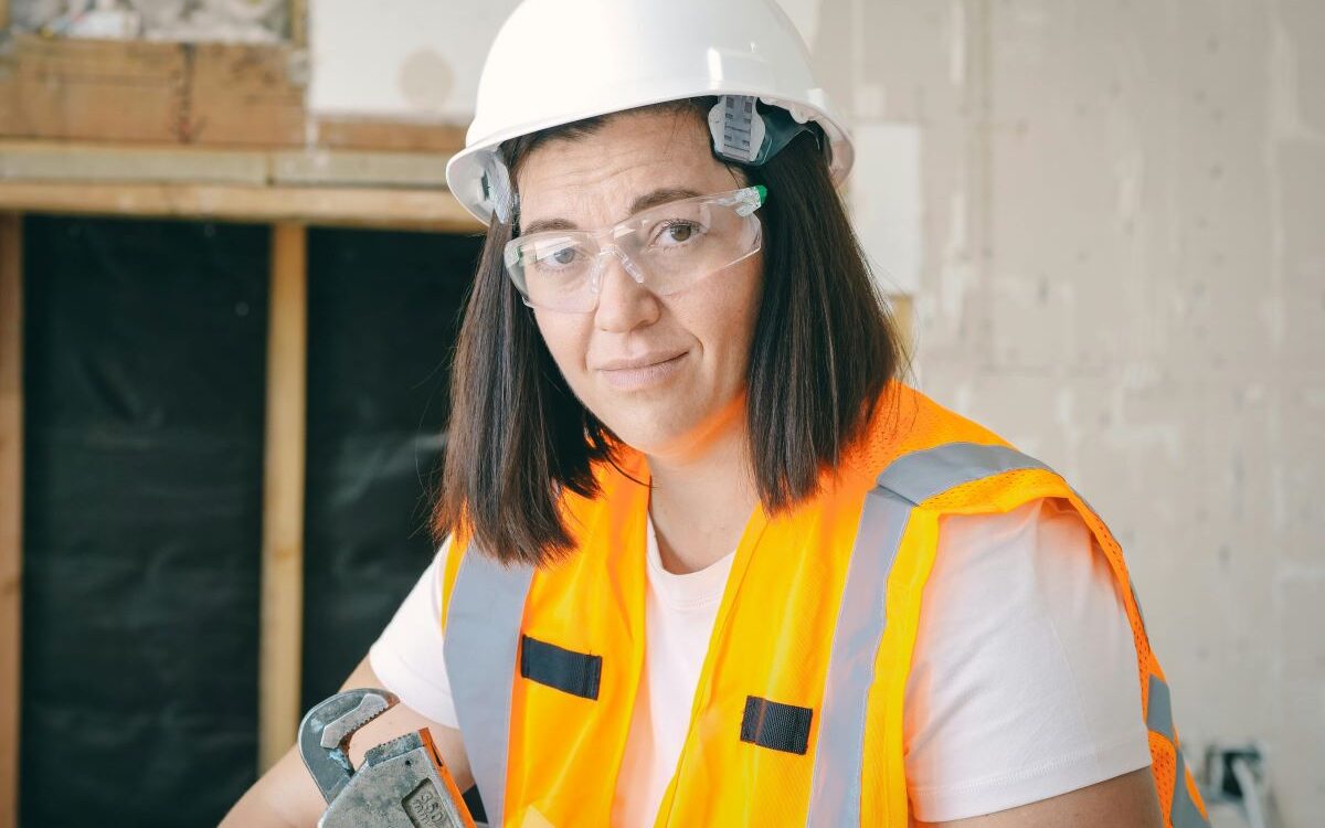 A plumber smiling in her uniform