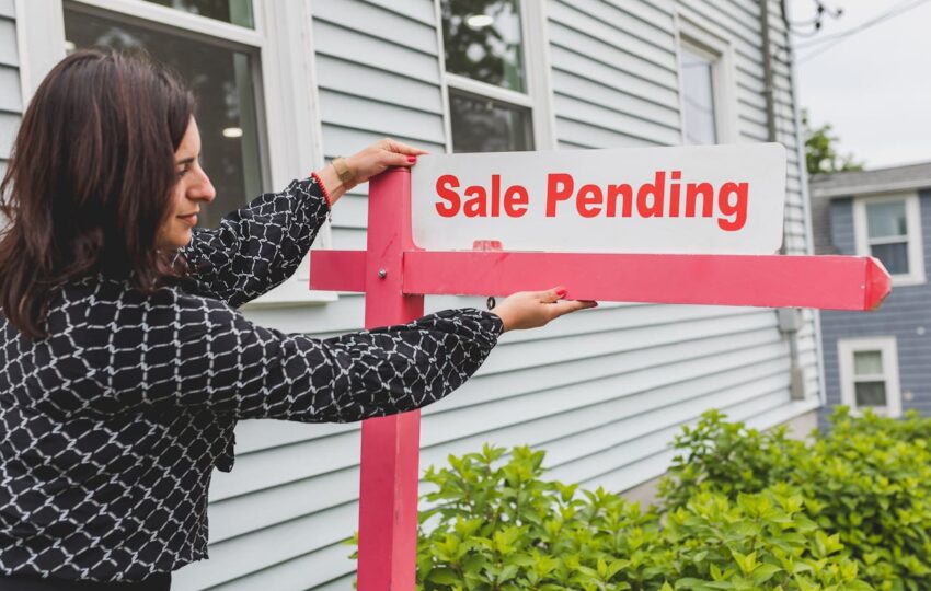 Real estate agent holding a signage