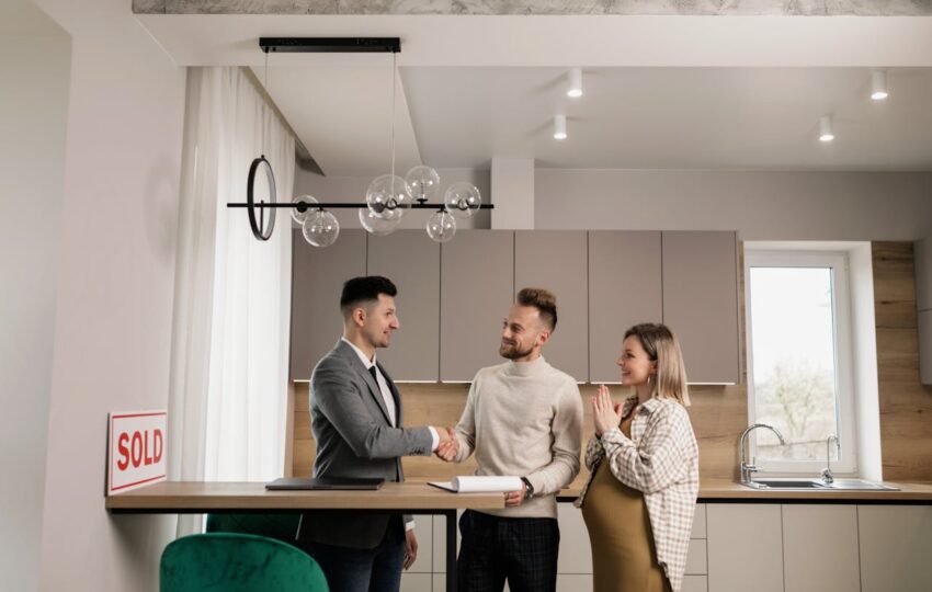 Two men doing a handshake in a kitchen